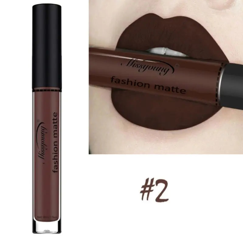 On the left is a tube of Léa Beauty & Cosmetics Non-Stick Matte Liquid Lipstick Lip Gloss Makeup in shade #2. On the right, lips wear the dark brown matte lipstick, holding the tube between them in a close-up view.