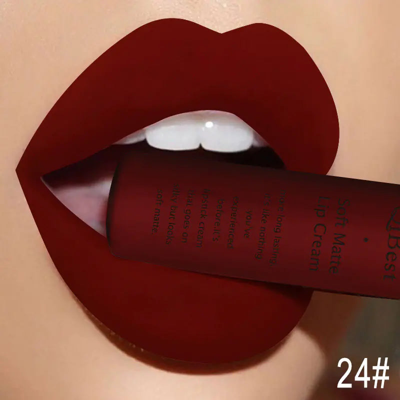 Close-up of lips wearing Léa Beauty & Cosmetics Matte Non-Stick Liquid Lip Gloss - Long-Lasting Finish in deep red, with a matching tube held between the lips and 24# shown at the bottom right corner.