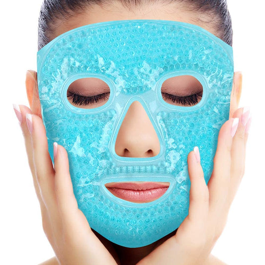 A person with closed eyes holds their face while wearing the Masque froid pour lacné by My Store, a blue gel bead mask that covers the full face with cutouts for eyes, nose, and mouth, known for its anti-inflammatory properties.