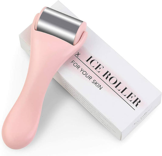A pink-handled Roulette de glace by My Store, featuring a silver metal roller head, rests on a white box labeled ICE ROLLER FOR YOUR SKIN, offering une sensation de fraîcheur and rapid soulagement for your skin.