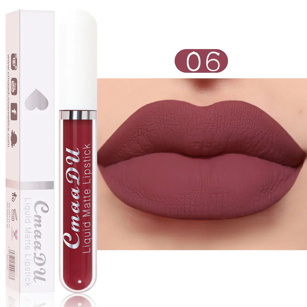 A tube of Léa Beauty & Cosmetics Matte Non-Stick Waterproof Long-Lasting Lip Gloss in shade 06 sits beside lips wearing the same deep mauve hue. The white packaging with a clear section shows off the rich, matte finish of this lip gloss.