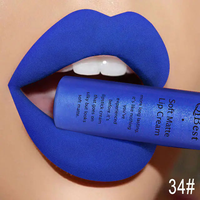 Close-up of lips in bold, matte blue Léa Beauty & Cosmetics Matte Non-Stick Liquid Lip Gloss, shade 34#, held between the teeth. The number highlights its vibrant, long-lasting color and non-stick finish.