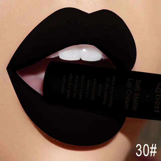 A close-up of lips wearing Léa Beauty & Cosmetics Matte Non-Stick Liquid Lip Gloss in shade 30#, slightly parted and holding the black tube, showcases its bold black, long-lasting matte finish.