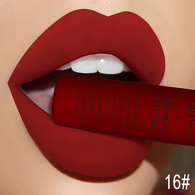 A close-up of lips wearing Léa Beauty & Cosmetics Matte Non-Stick Liquid Lip Gloss - Long-Lasting Finish in shade 16#, with a matching tube held between the teeth and the shade number 16# shown at the bottom right.